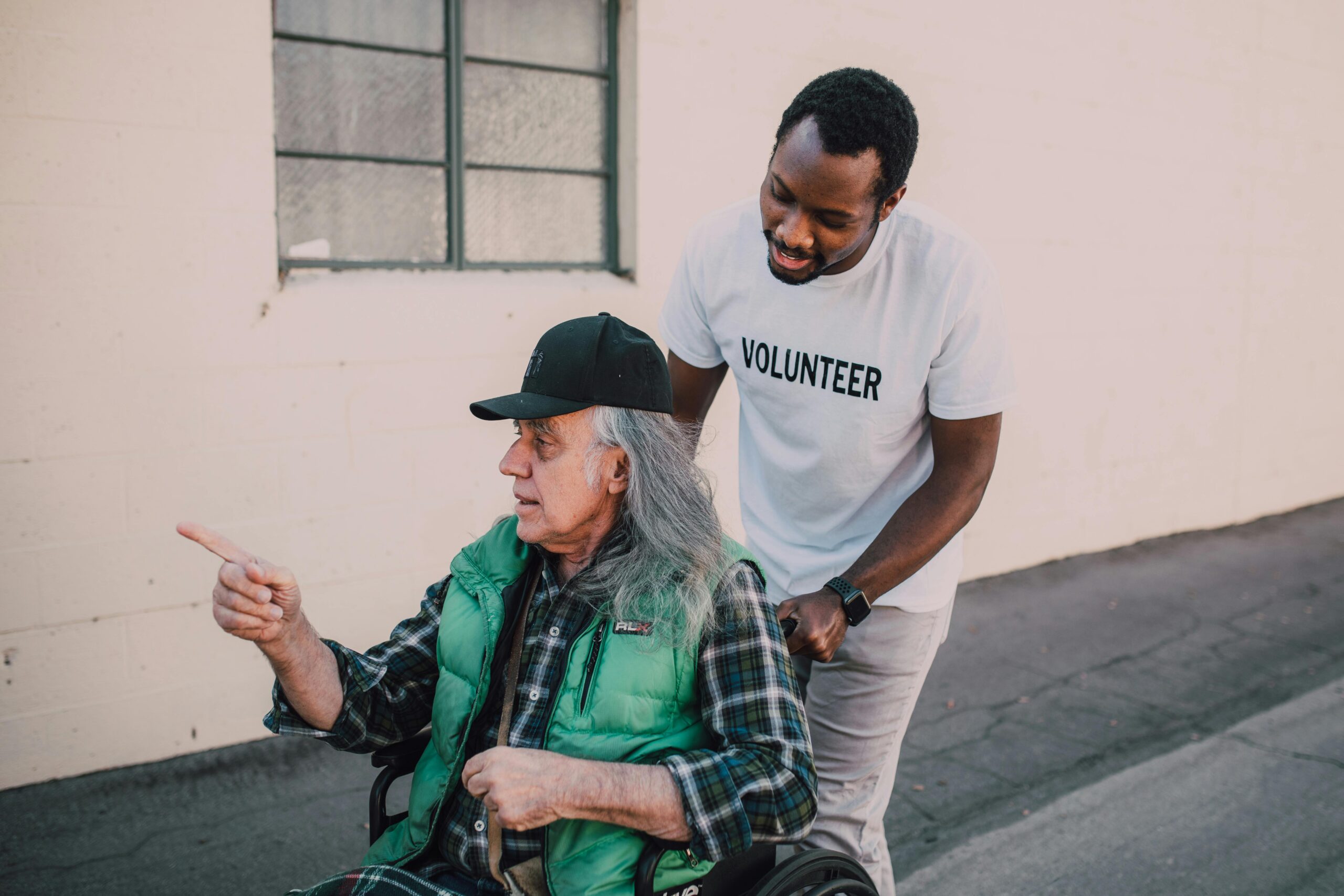Older adult being helped by a community volunteer